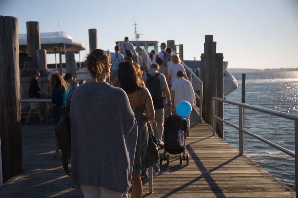 Passengers boarding a Seine cruise boat at a Paris pier in late afternoon, no text, no logos, no people