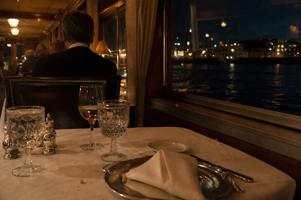 Formal dinner table setting with glassware on a river cruise boat, no text, no logos, no people.