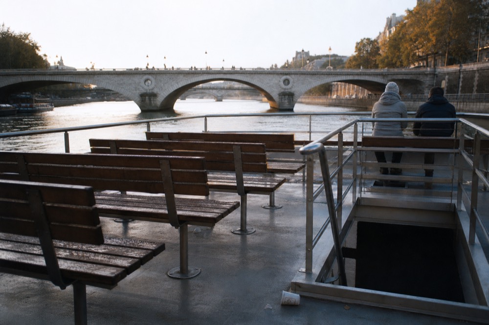 Open upper terrace of a river shuttle with benches facing the Seine bridges, no text, no logos, no people