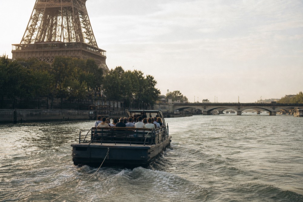 Sightseeing boat on the Seine with the Eiffel Tower and Pont d'Iena behind it, no text, no logos, no people